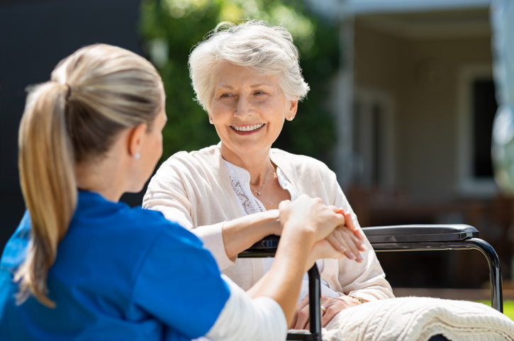 Nurse takes care of old patient Pflegegrad 5